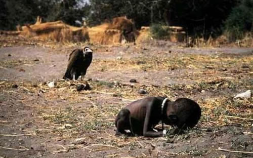 Stricken child crawling towards a food camp